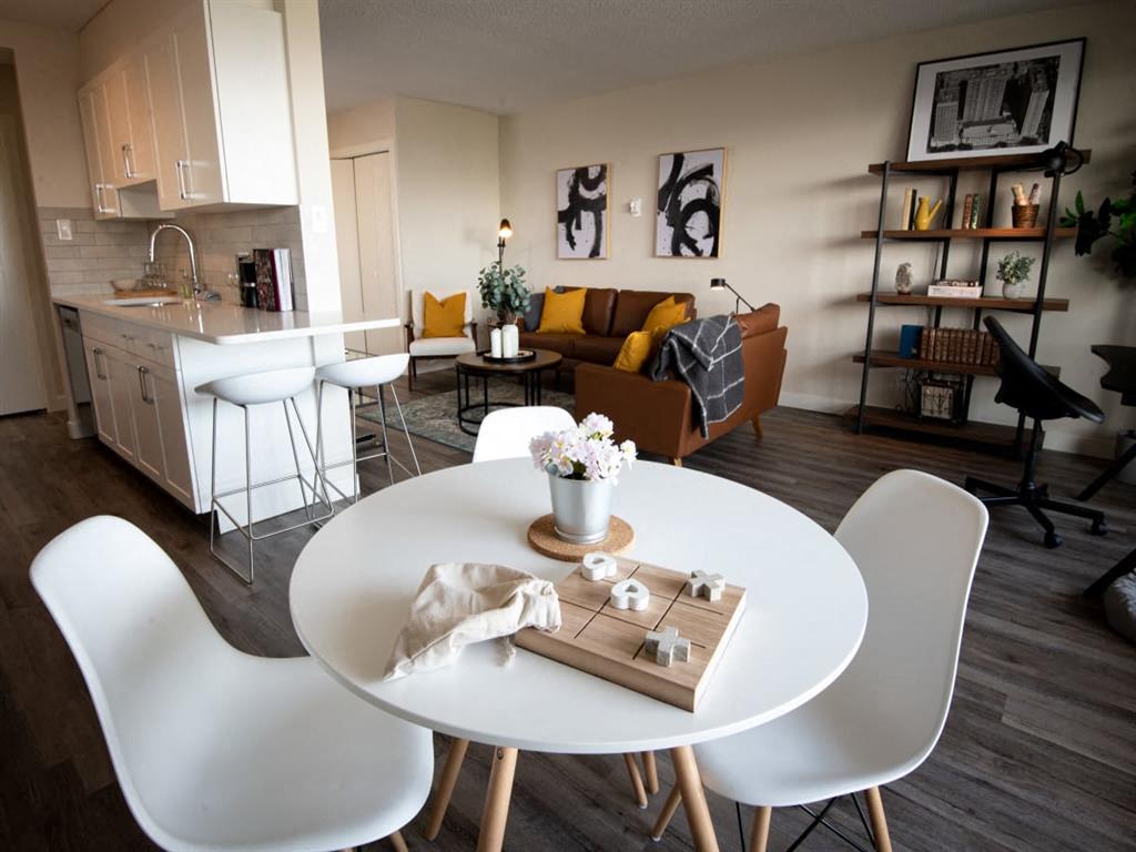 a living room and dining room with a table and chairs