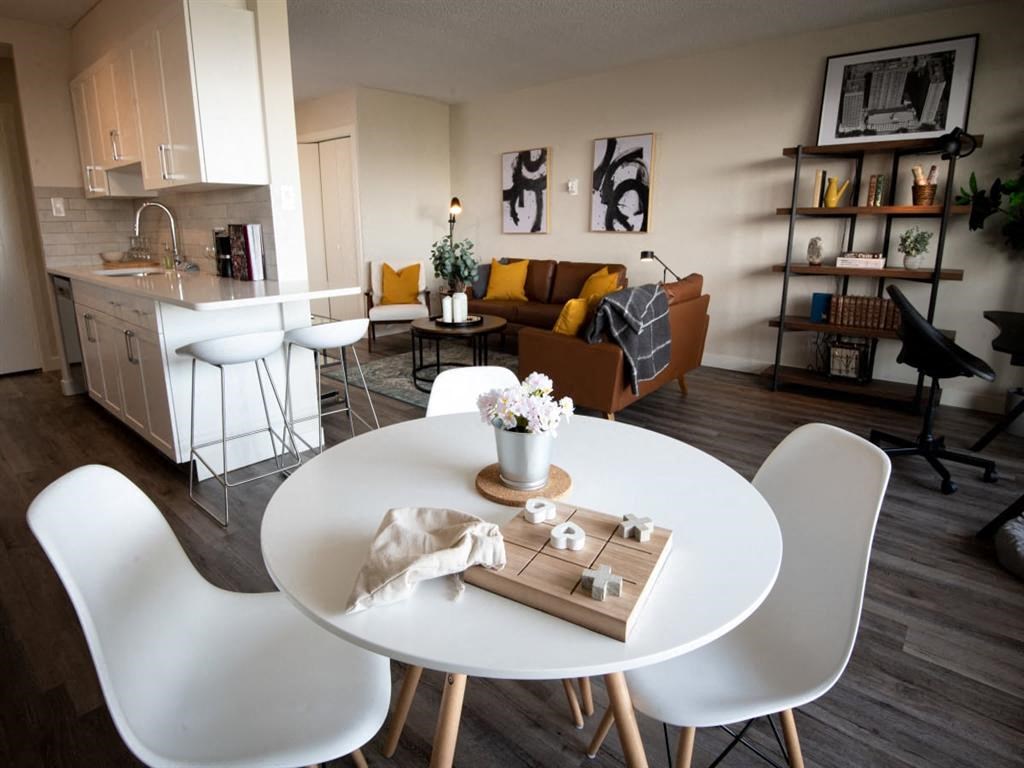 a living room and dining room with a table and chairs