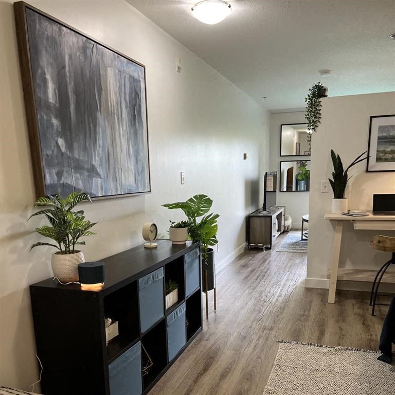 an empty living room with a painting on the wall
