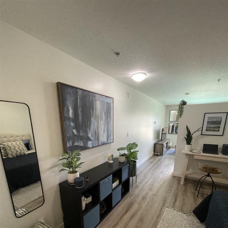 a living room with a black table and a mirror