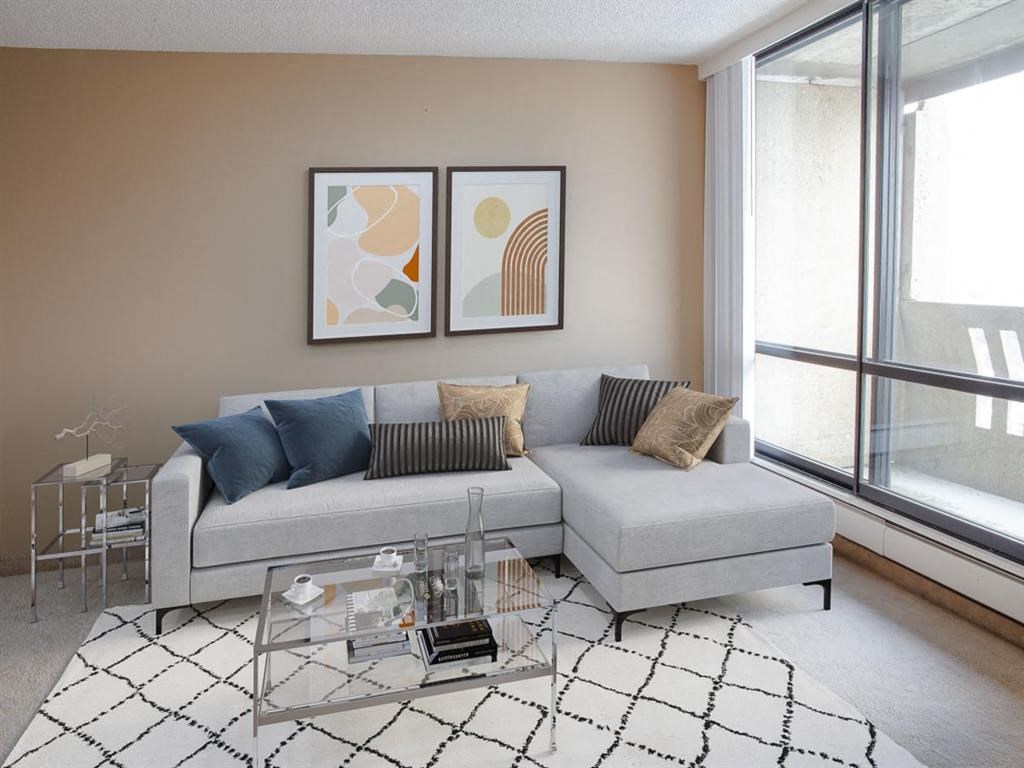 a living room with a couch and a glass coffee table