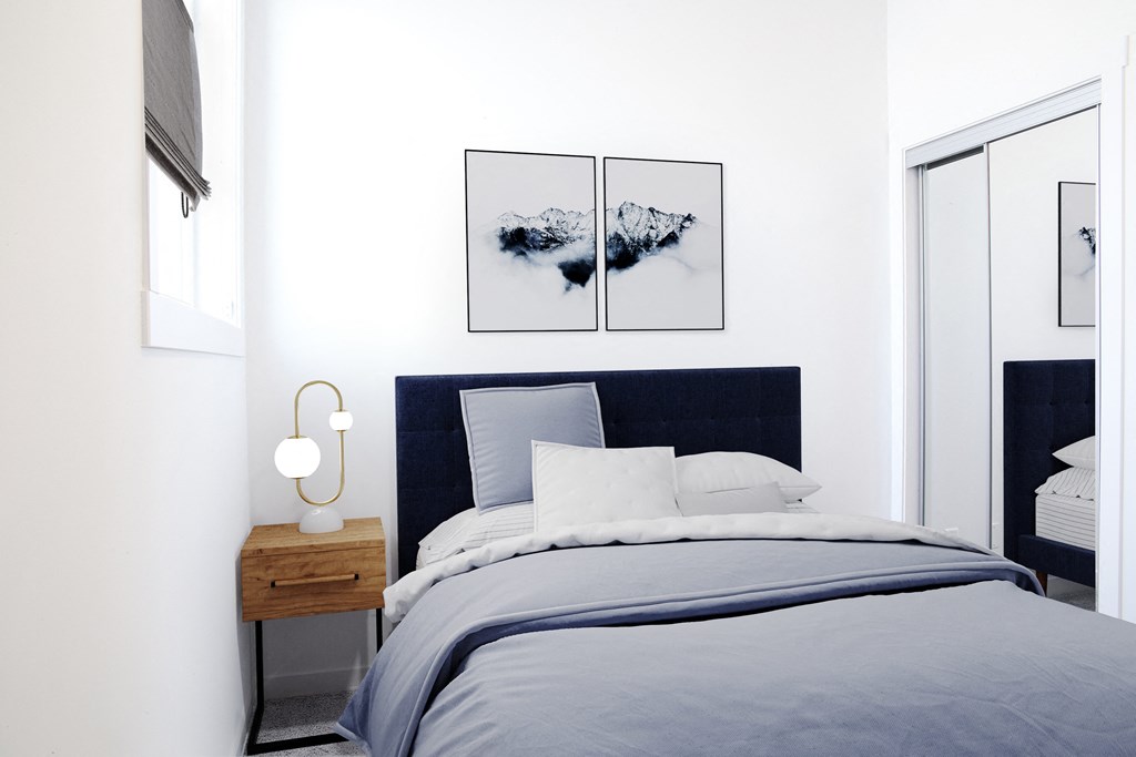 a bedroom with a bed and two pictures on the wall