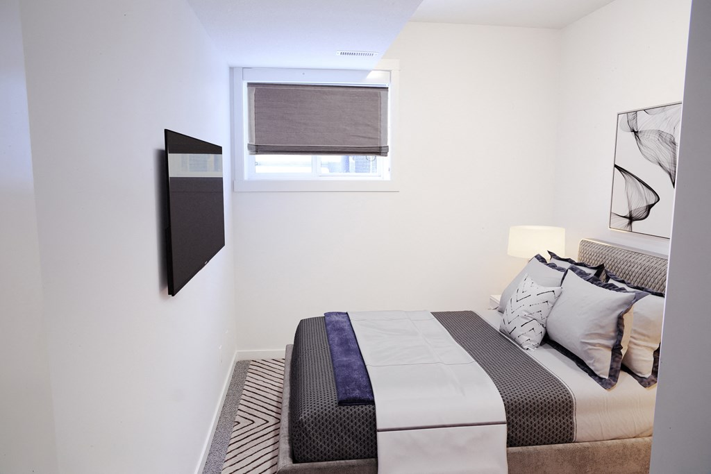 a small bedroom with a bed and a window