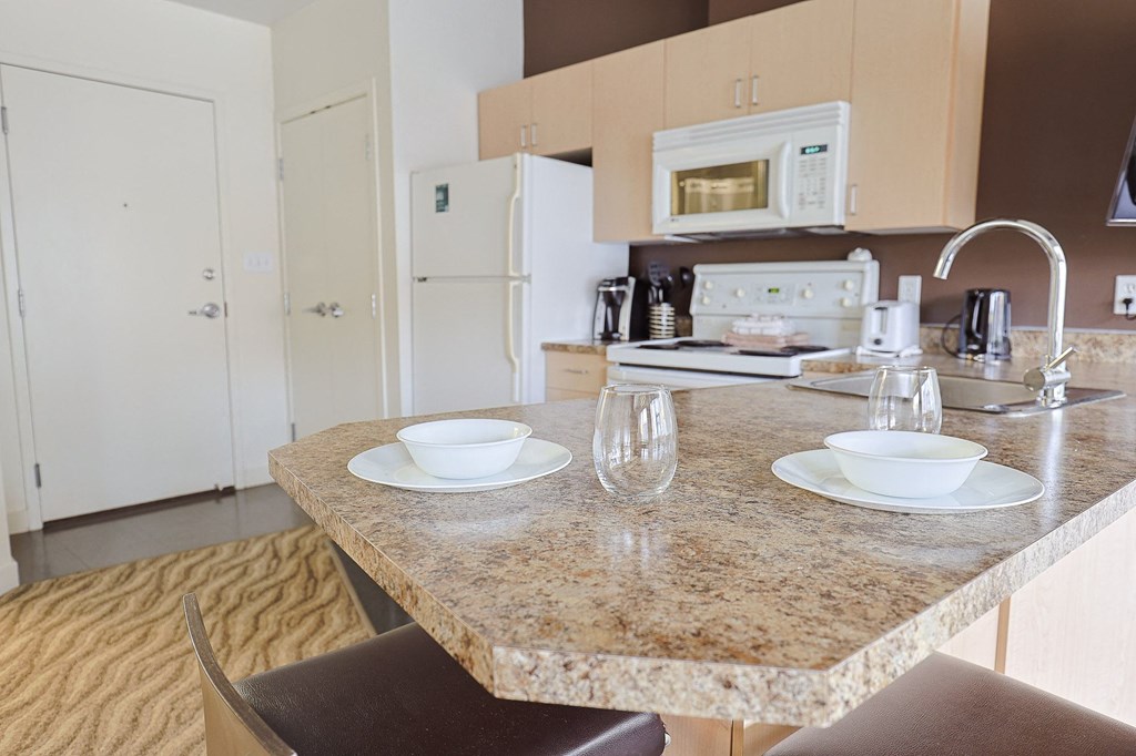 a kitchen with a counter with plates and bowls on it