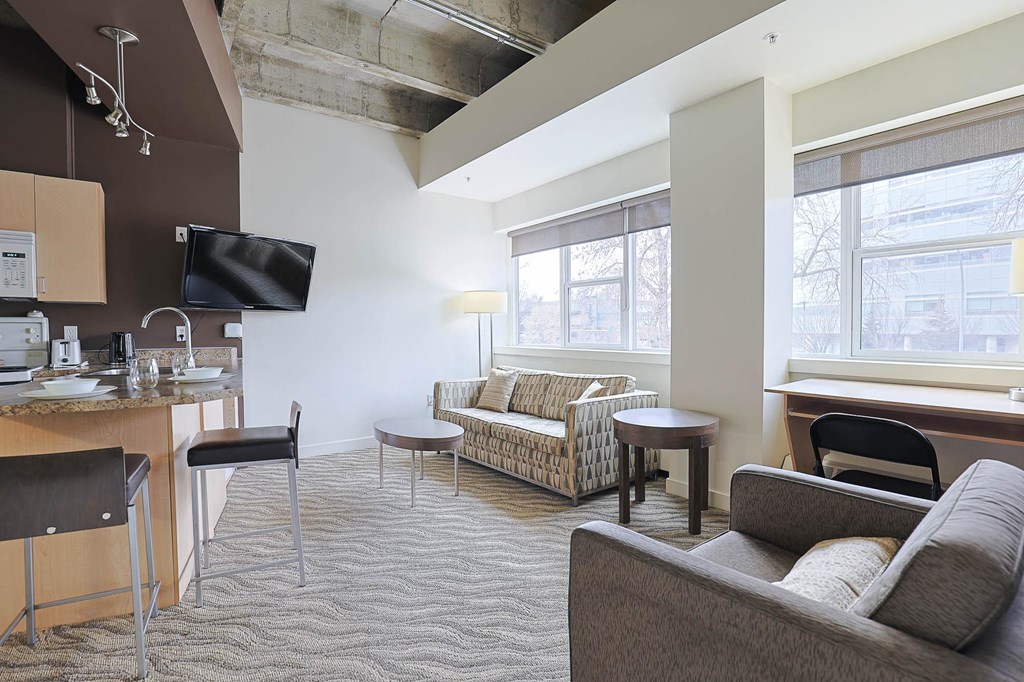 a living room and kitchen in a hotel room