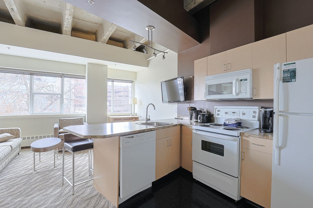 a kitchen with an island and a stove and a microwave