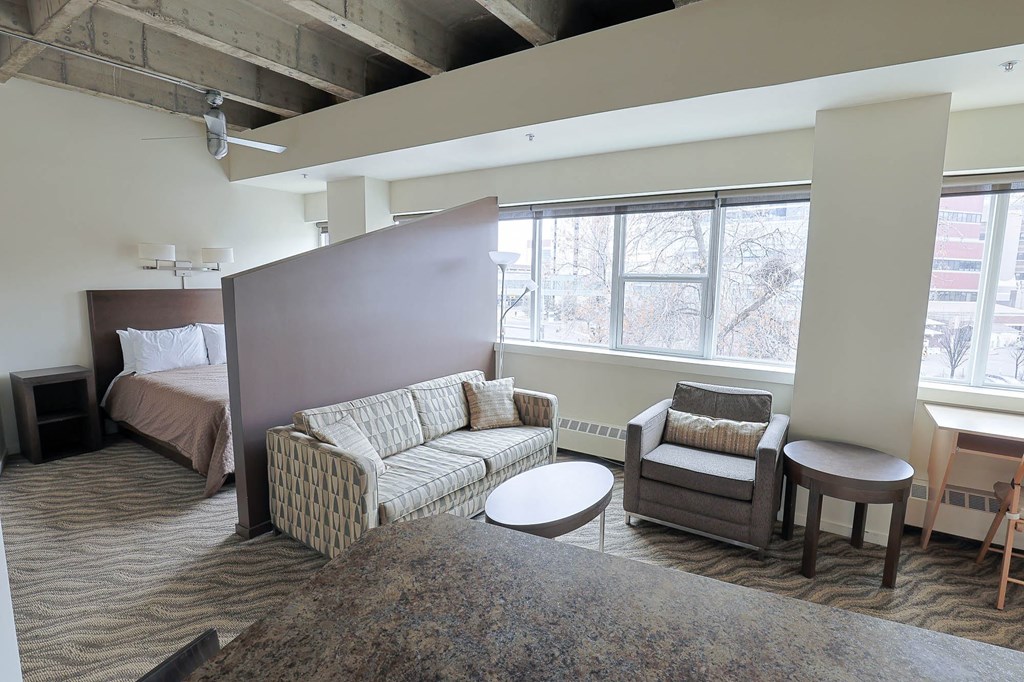 a living room and bedroom in a hotel room