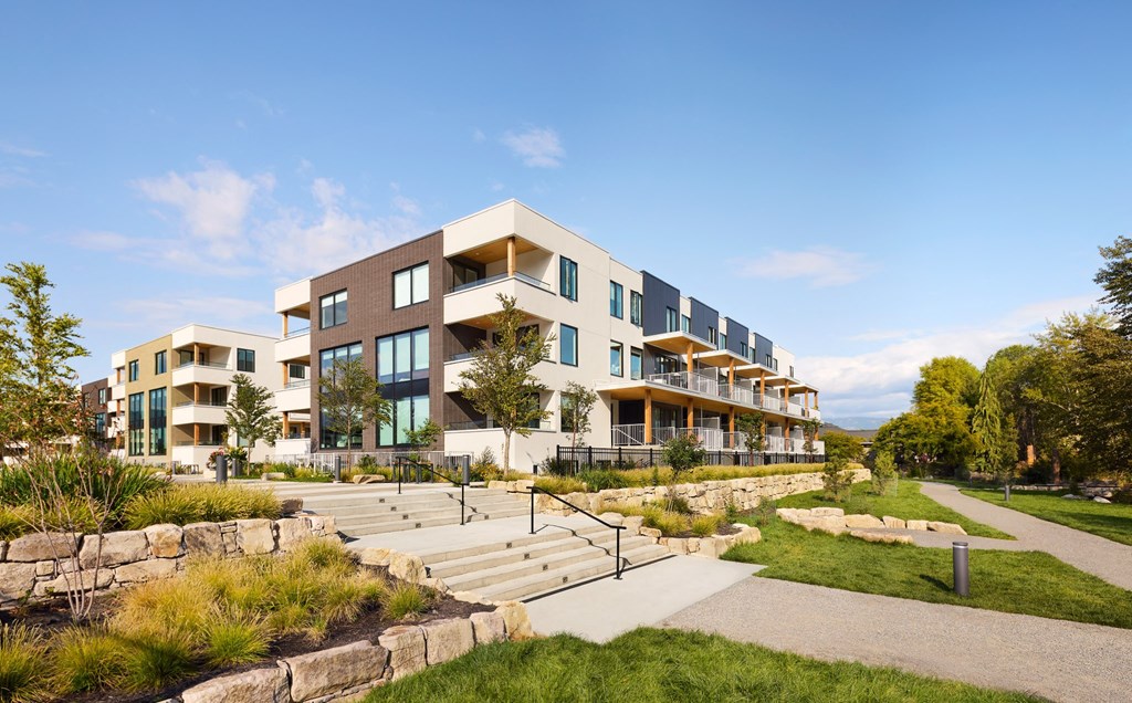 A modern building with a stone pathway leading to the entrance.