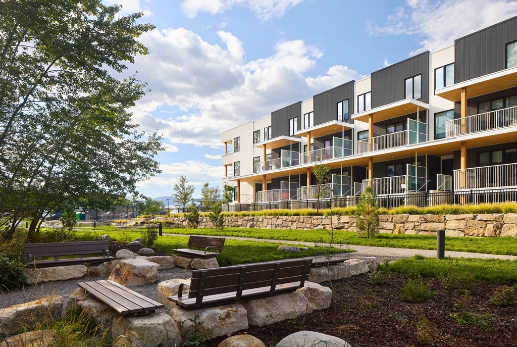 A modern building with a garden in front.