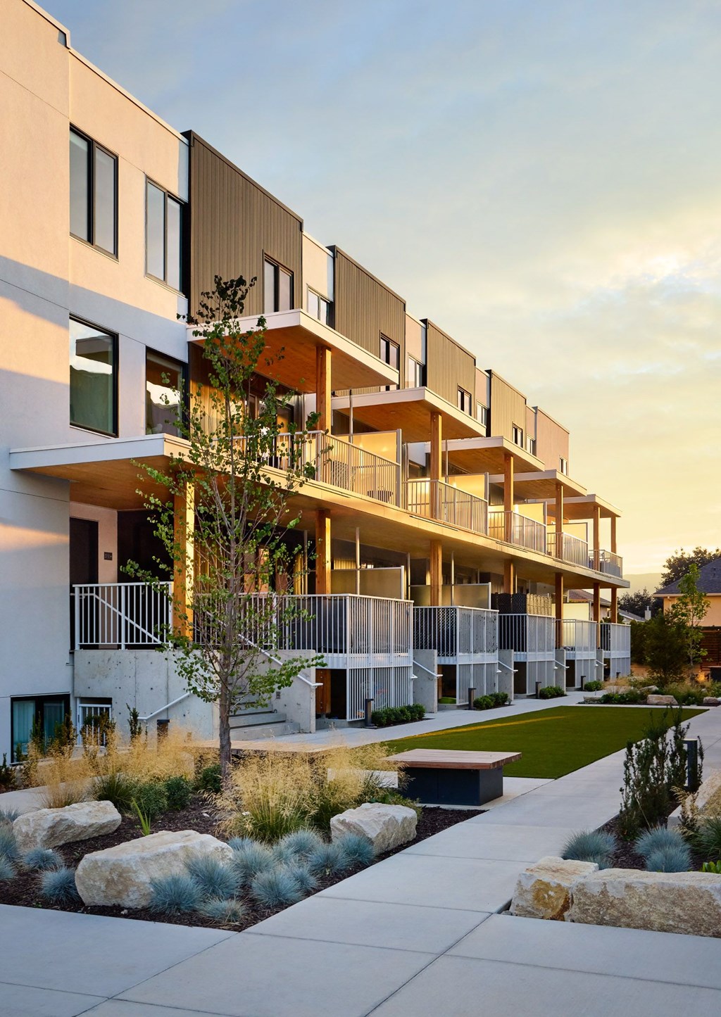 A modern apartment complex with a landscaped courtyard.
