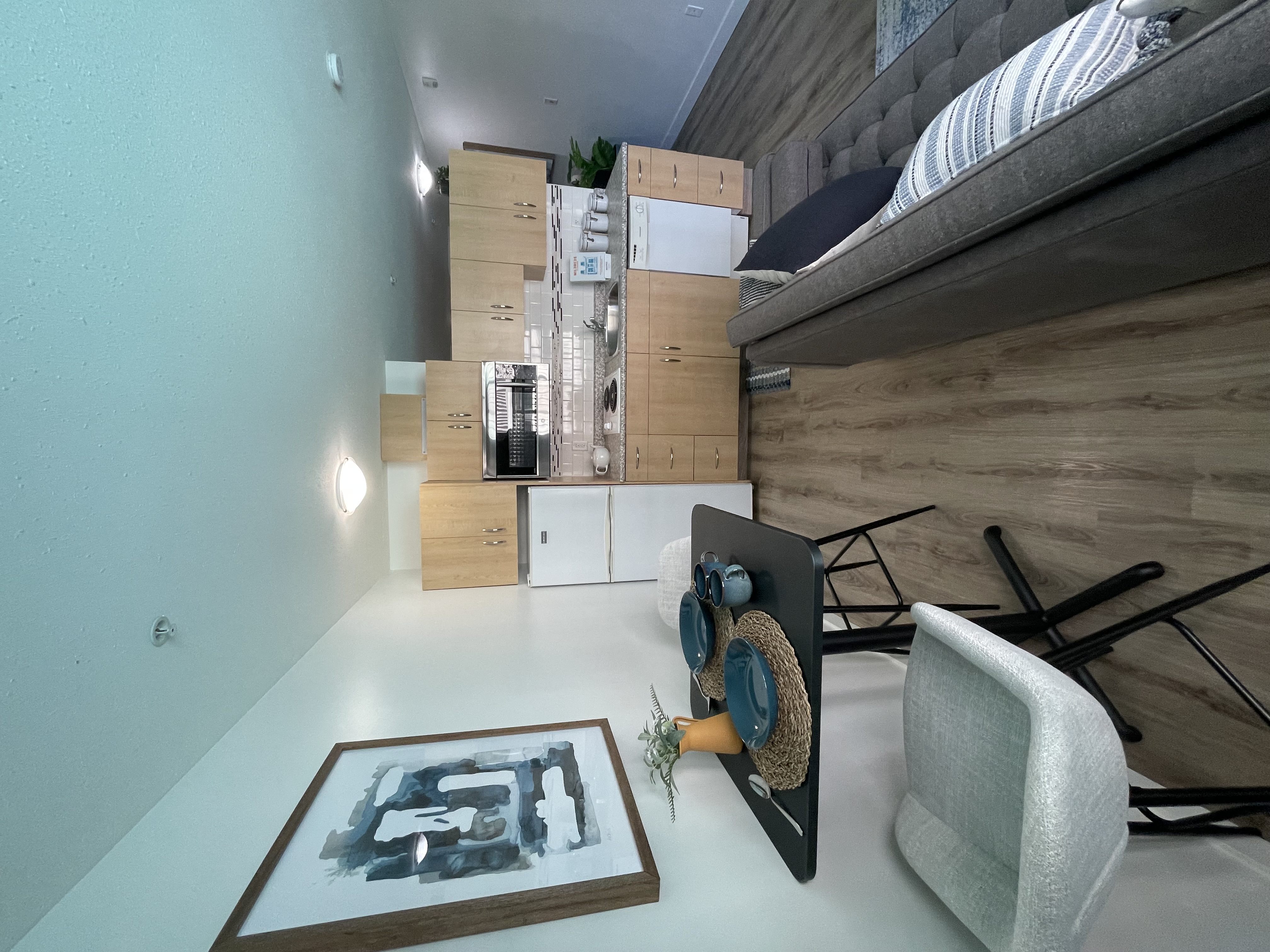 a bedroom with a bed and a chair in a room