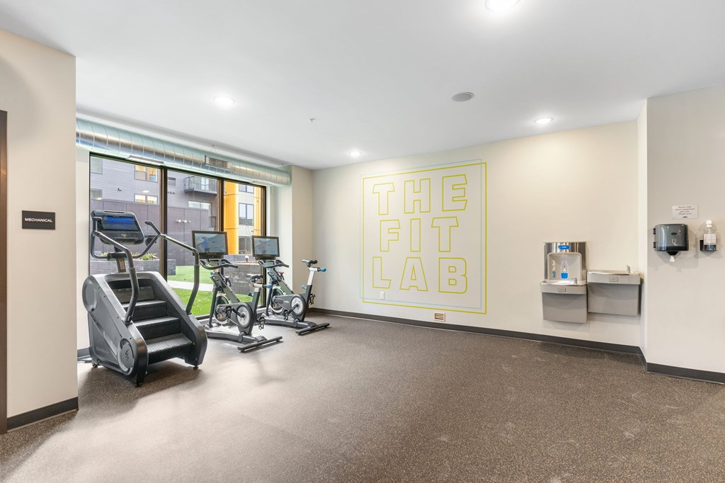 A gym room with a sign that says "The Fit Lab".
