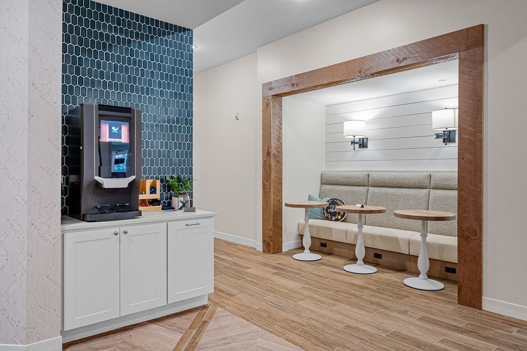 a living room with a coffee machine and a seating area