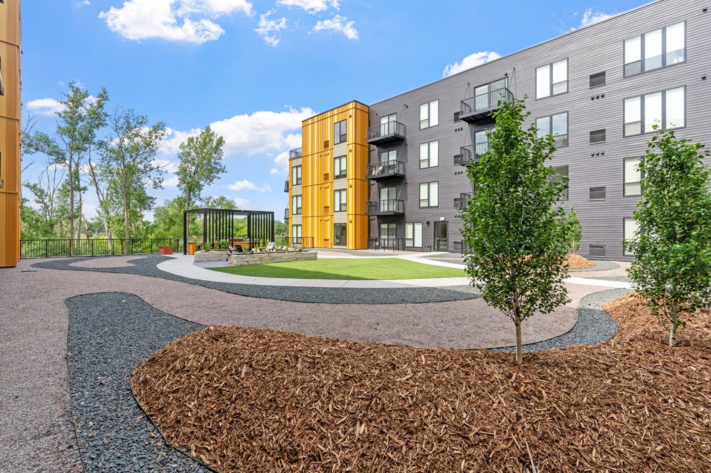 A modern apartment complex with a landscaped courtyard.