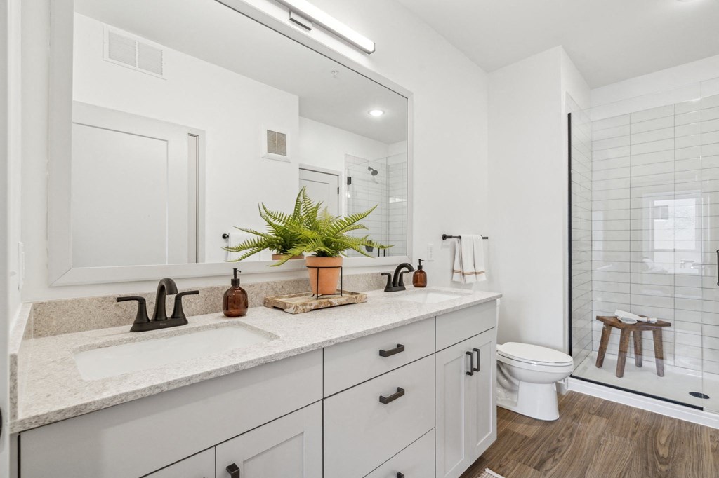A bathroom with a white sink and a white toilet.
