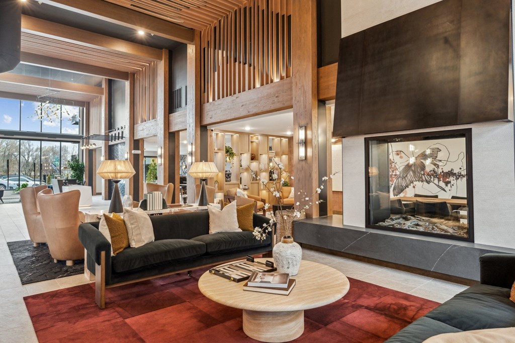 A modern living room with a fireplace and a large window.