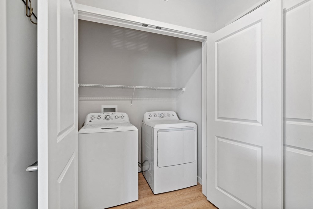 a washer and dryer in a laundry room with white doors