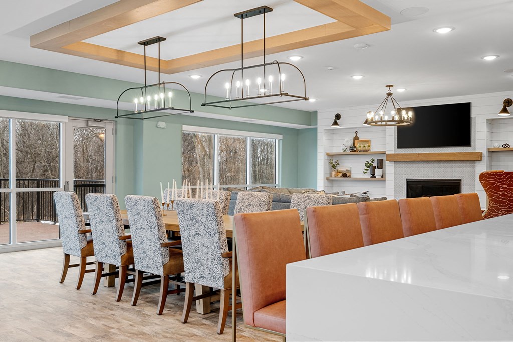 a large dining room with a long table and chairs and a fireplace