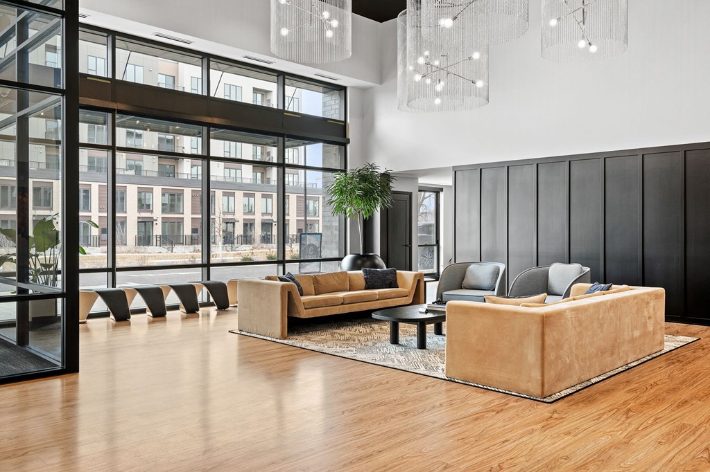 a lobby with couches and chairs and a large window