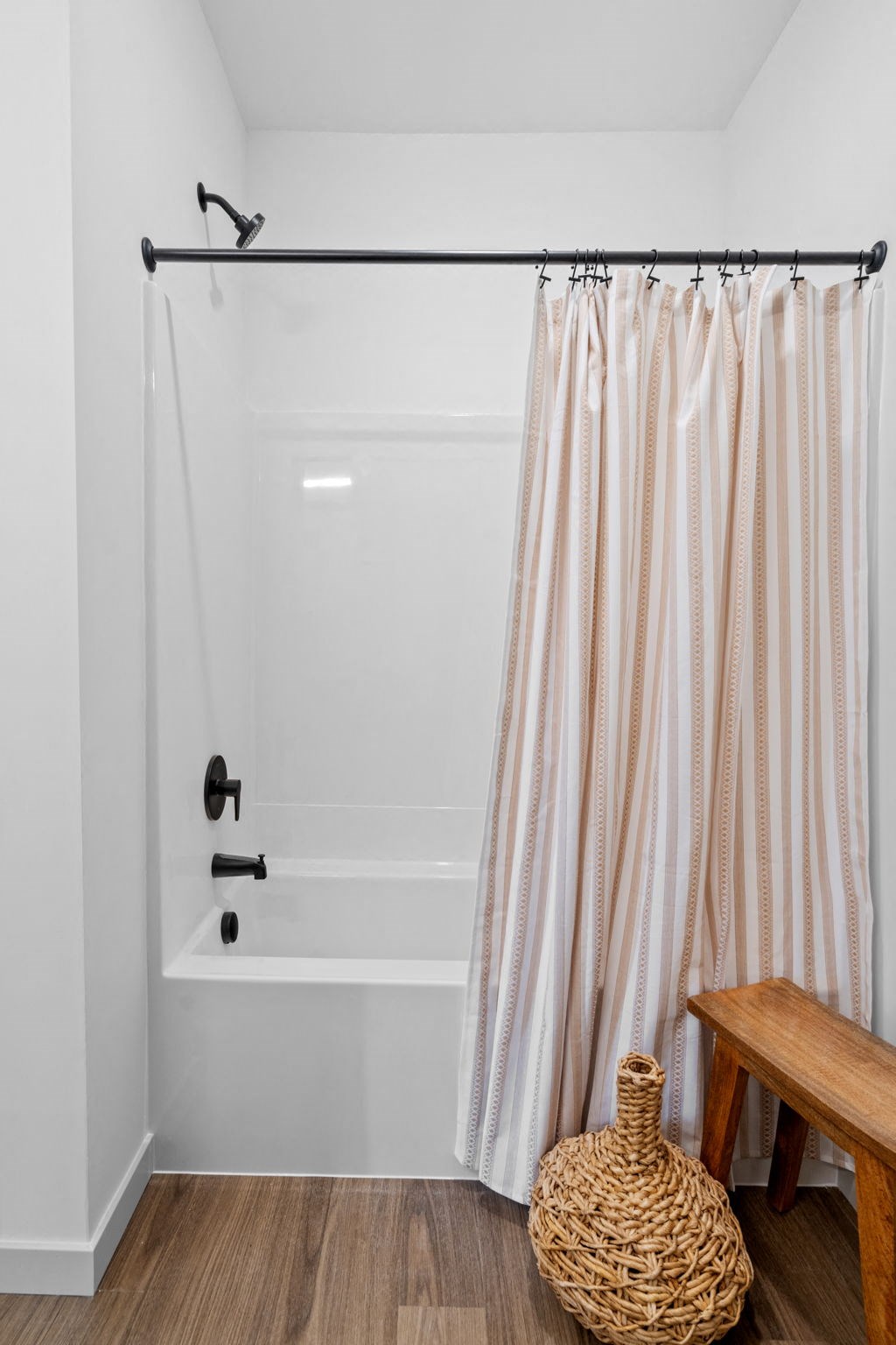 a bathroom with a shower curtain and a bath tub