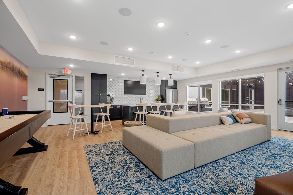 a living room with a couch and a table with chairs