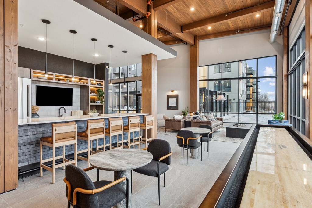 A modern kitchen and dining area with a bar and seating.