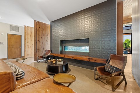 A modern living room with a fireplace and a chair.