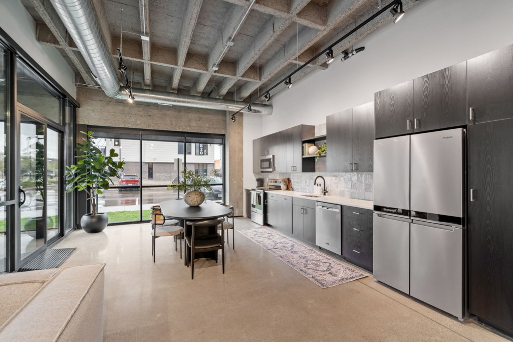 a kitchen with stainless steel appliances and a dining table