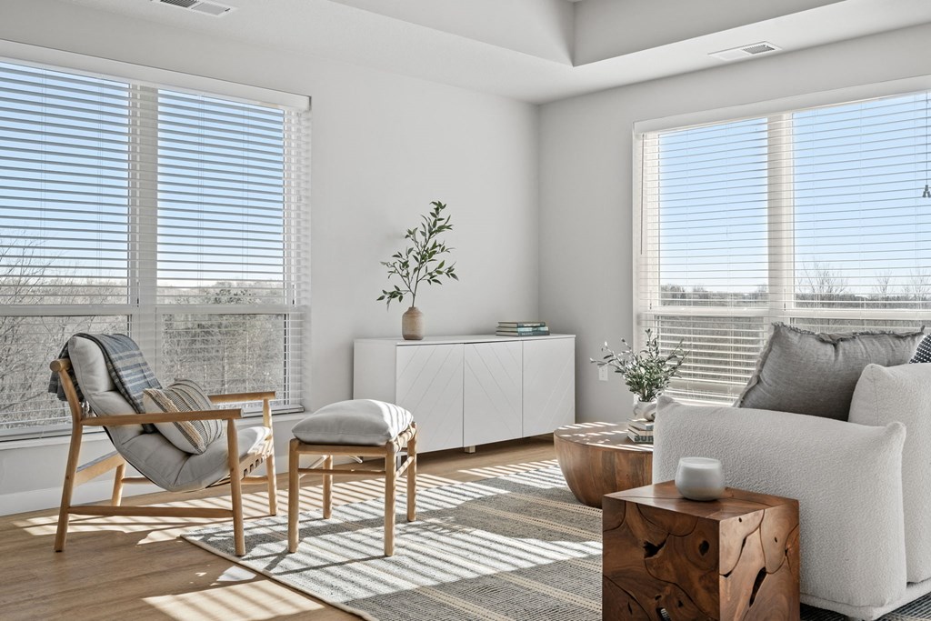 a living room with a couch and chairs and a table
