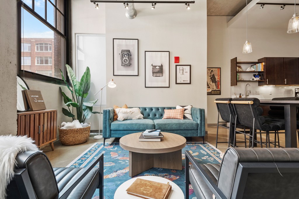 A living room with a blue couch and a coffee table.