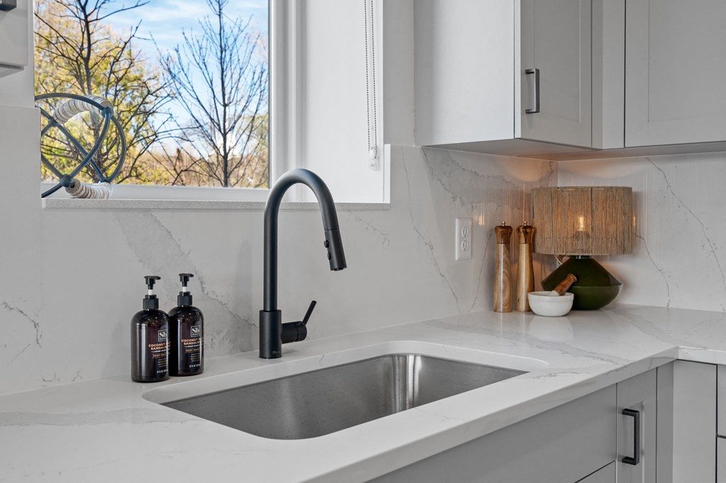 a kitchen sink with a window over it
