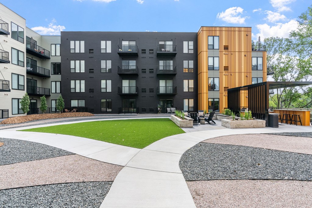A modern apartment complex with a mix of black and wooden buildings.