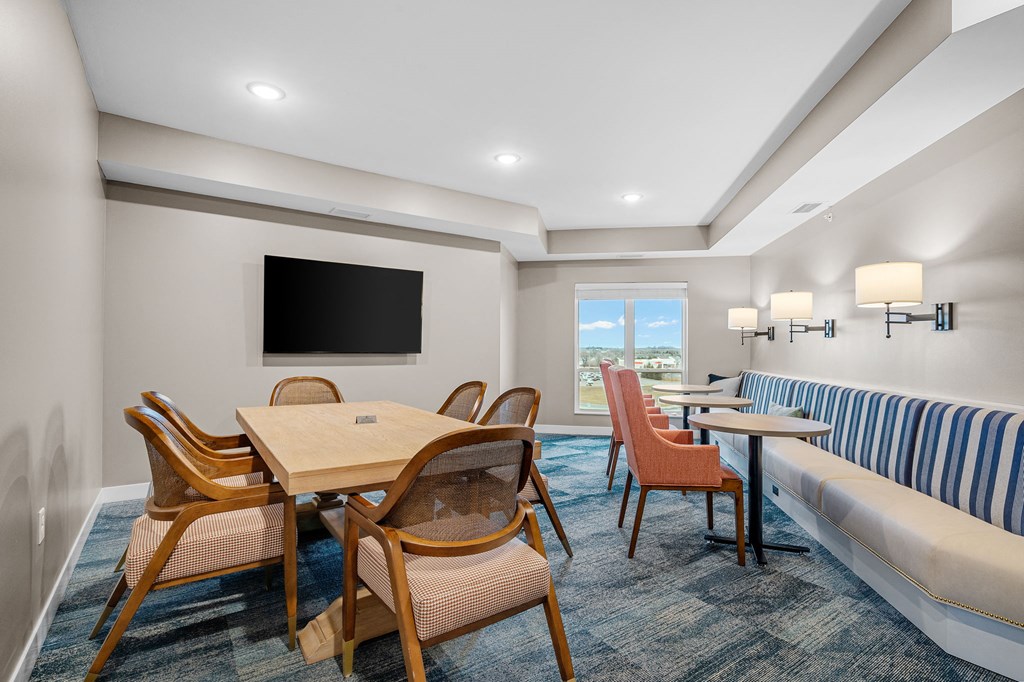 a living room with a table and chairs and a couch