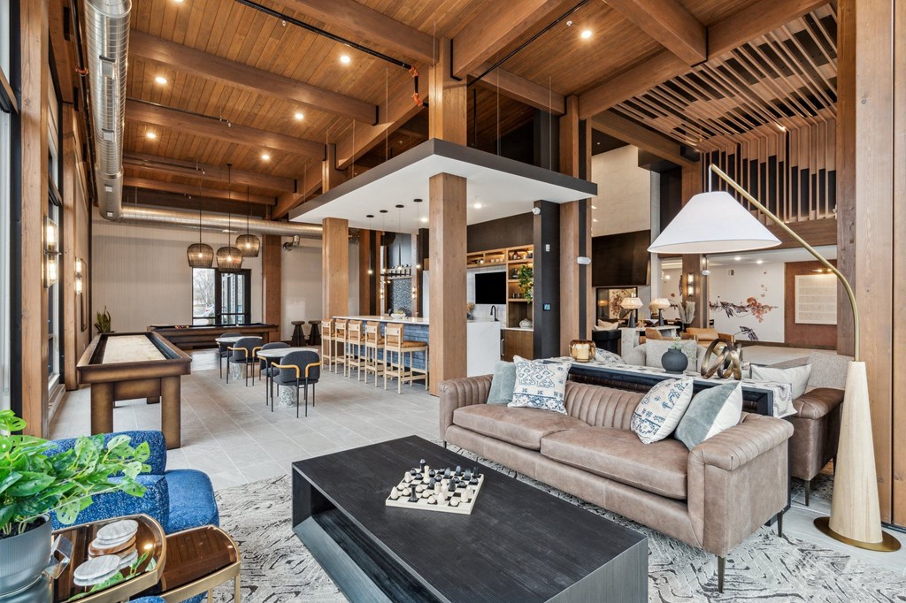 A living room with a brown couch and a black coffee table.