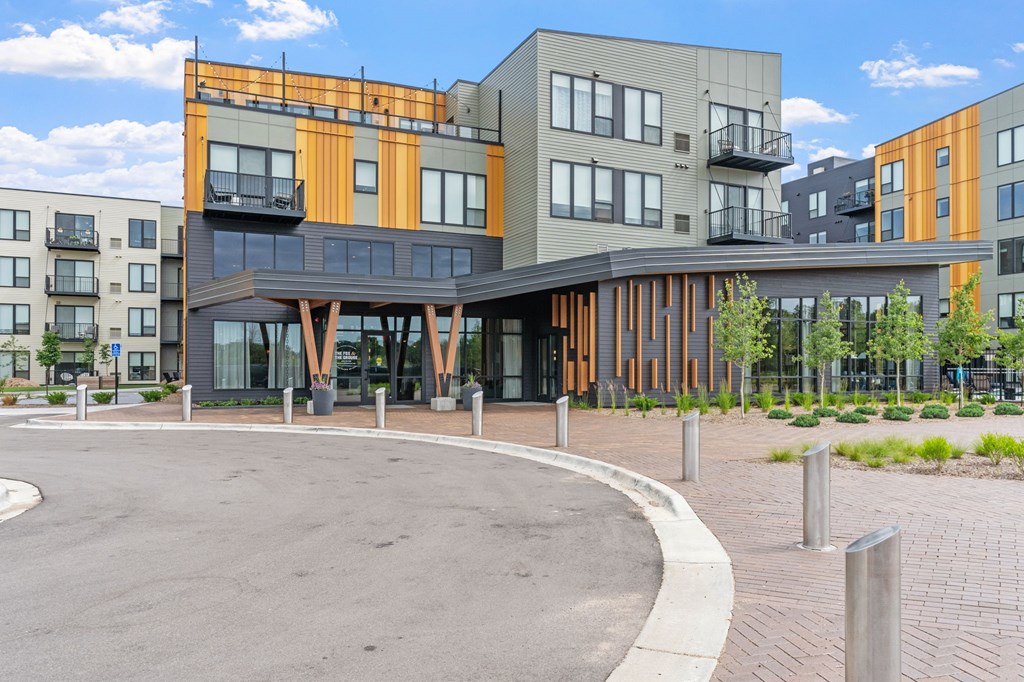 A modern building with a circular driveway in front.