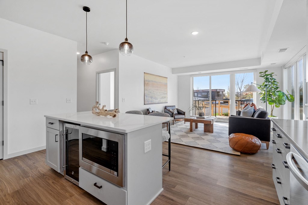 an open living room with a kitchen and a living room area with a table