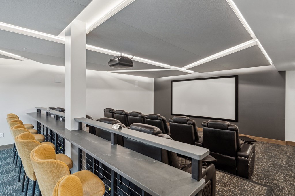 A row of chairs are lined up in front of a screen.