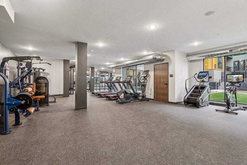 A spacious gym with various exercise equipment.