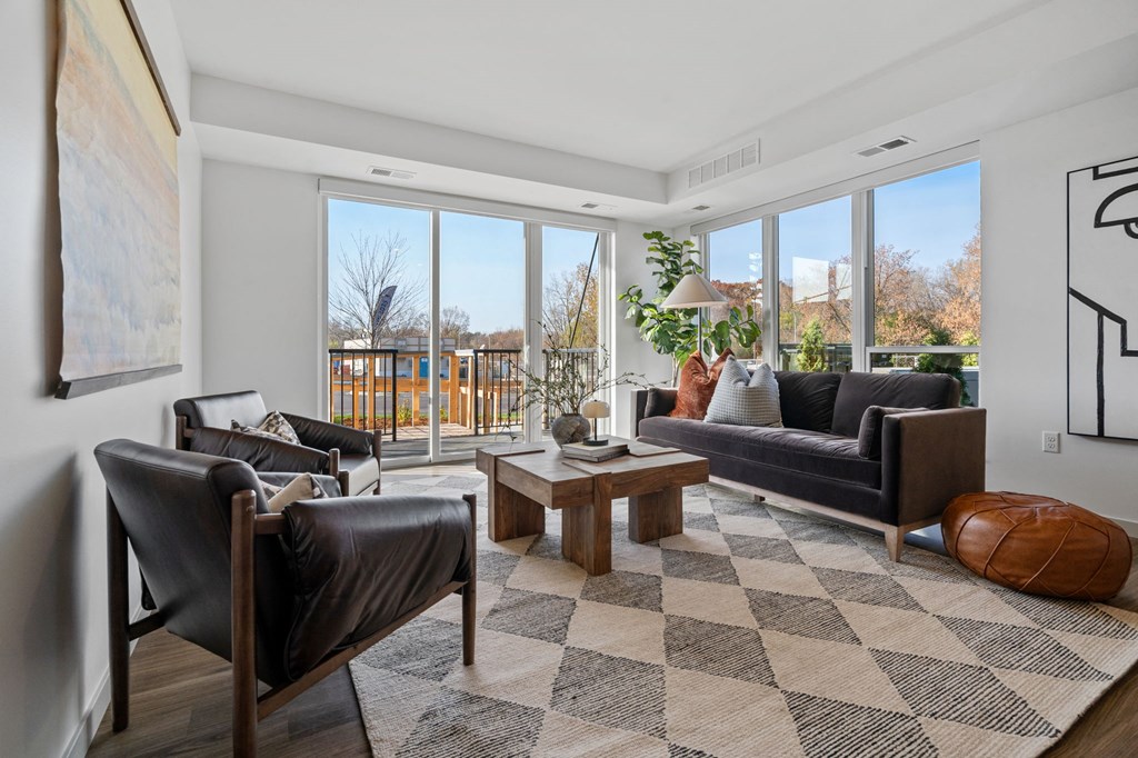 a living room with leather furniture and large windows