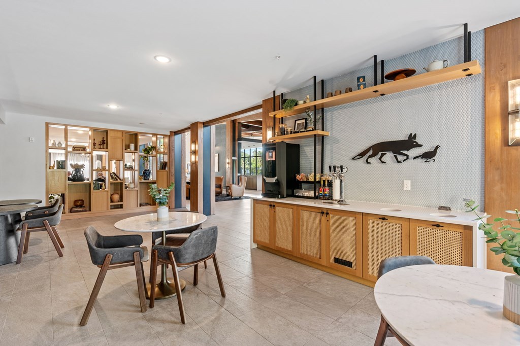 A modern kitchen with a dining table and chairs.