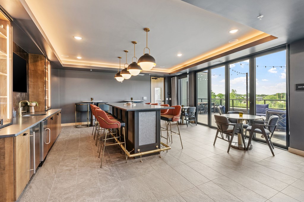 A modern kitchen with a dining table and chairs.