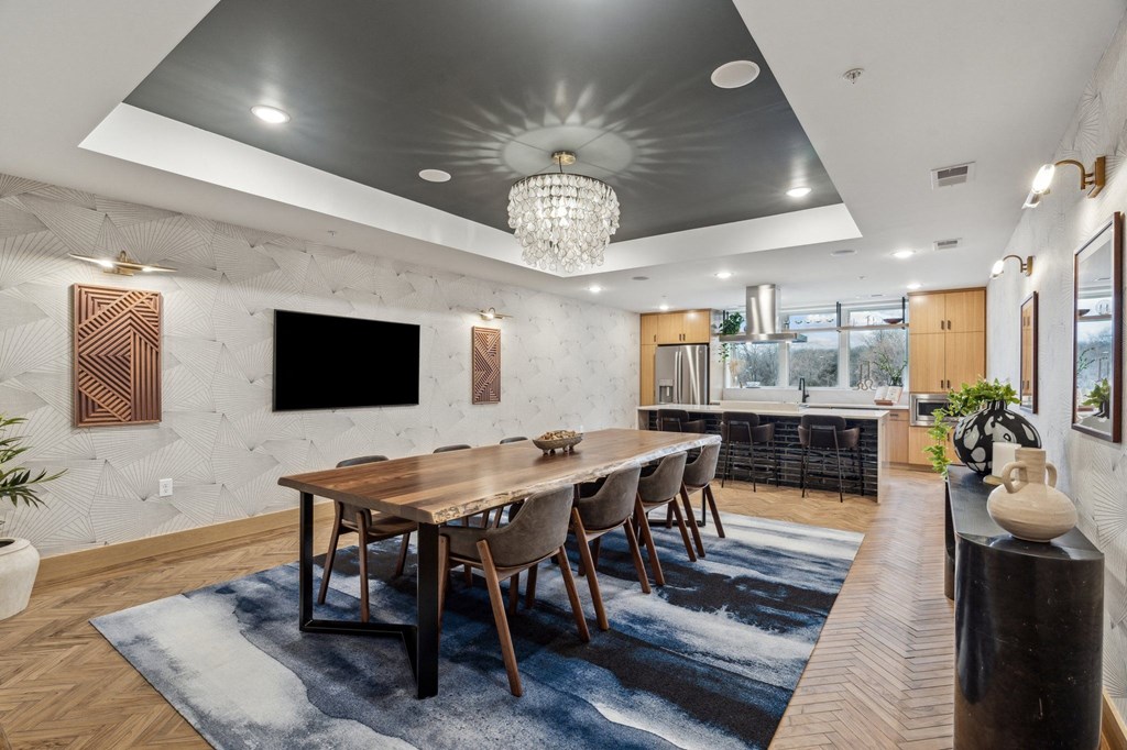A modern dining room with a wooden table and chairs.
