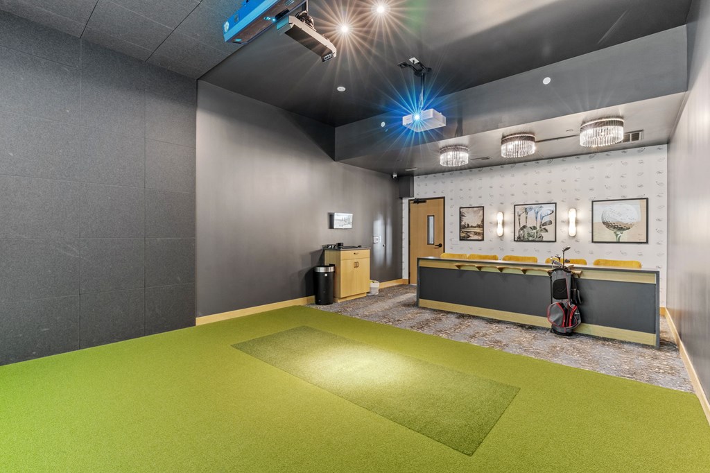 A room with a green floor and grey walls.