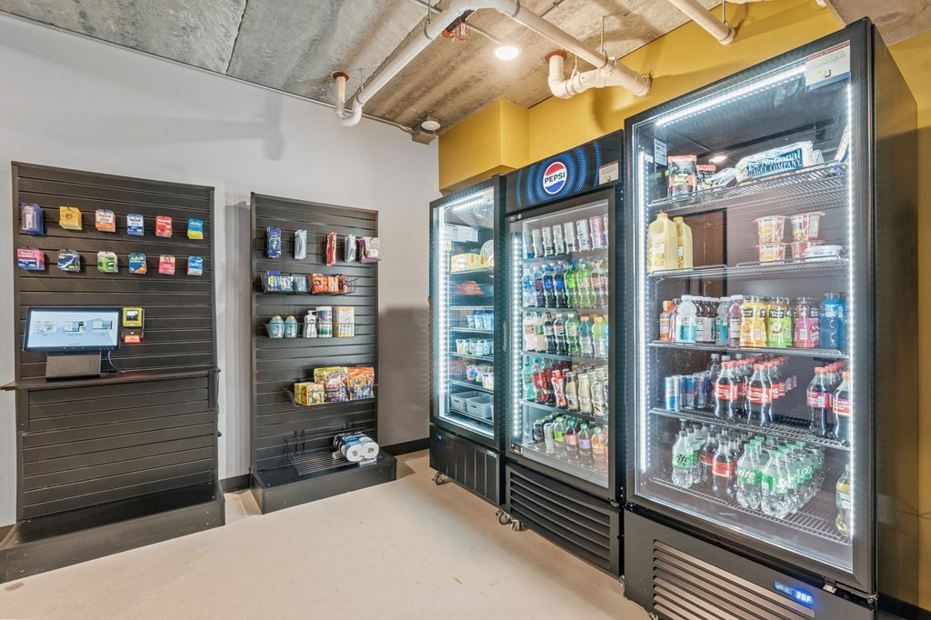 A Pepsi vending machine is next to a soda machine.