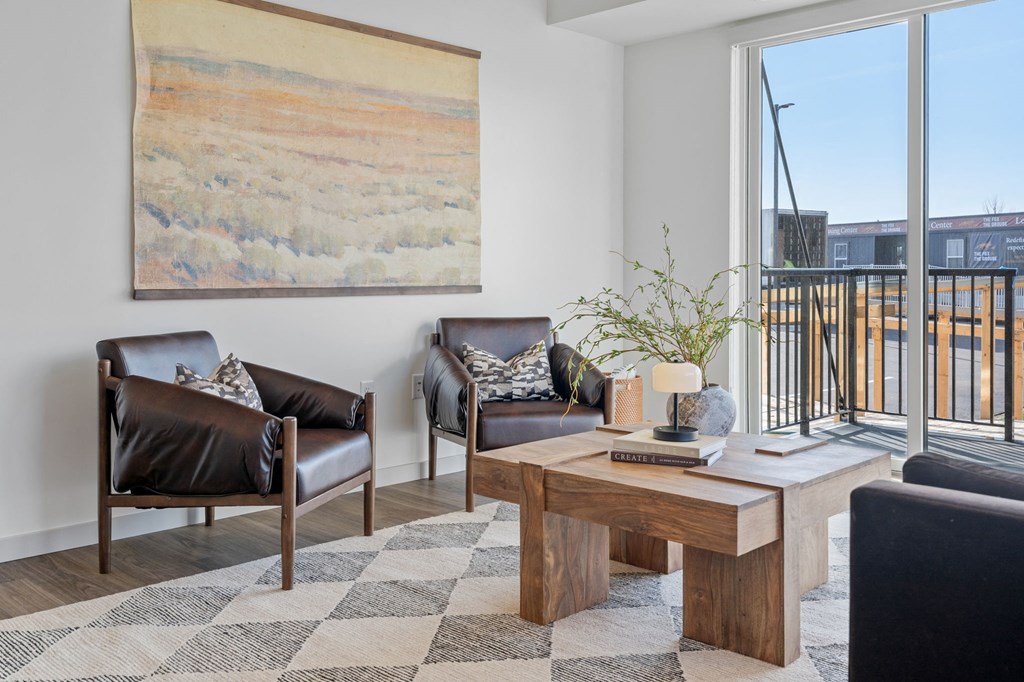 a living room with leather furniture and a large window