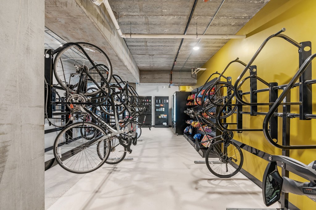 A bike rack with many bicycles parked in it.