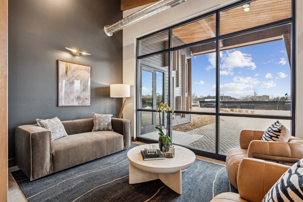 A living room with a sofa, armchair, and coffee table.