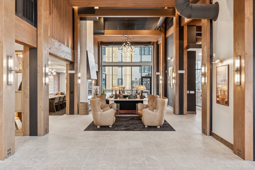 A spacious lobby with a large table and chairs.
