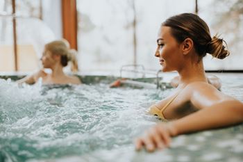two women in a jacuzzi swimming in the water