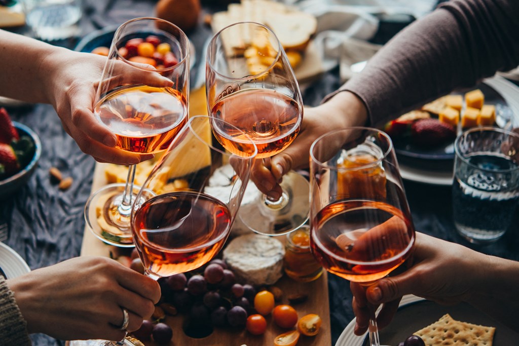 a group of people holding wine glasses over a table